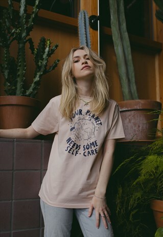 PALE PEACH T-SHIRT WITH "YOUR PLANET NEEDS SOME SELF CARE"