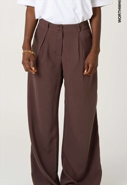 High-waisted wide brown leg pants. Pleat detail. Welt pocket
