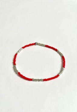 Red and silver elastic beaded bracelet. Handmade item.