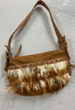 Tan Suede Feather bag.  Zip opening. One cental Pocket. 