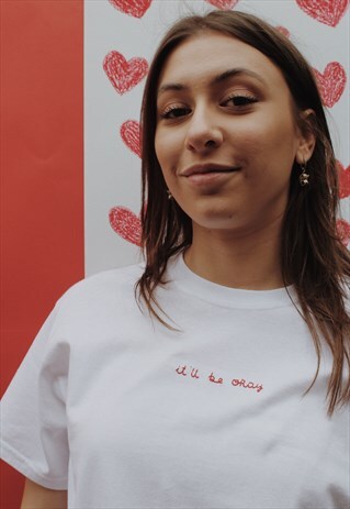 WHITE T-SHIRT HAND EMBROIDERED IN RED WITH A SELF LOVE MOTIF