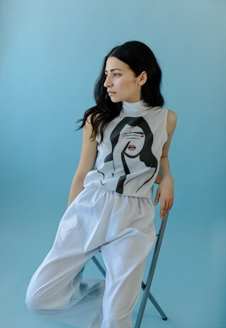 WHITE SLEEVELESS JUMPSUIT WITH FACE PRINT AND TURTLENECK