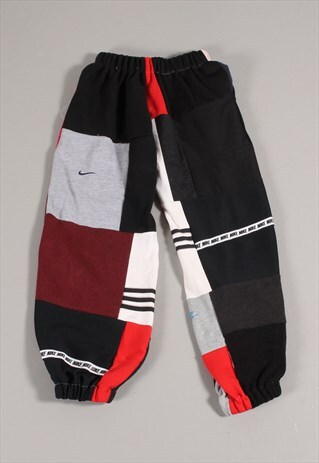 REWORKED VINTAGE NIKE PATCHWORK JOGGERS IN RED BLACK SMALL