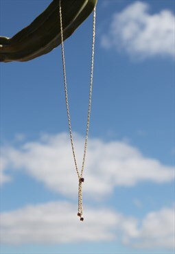 Deadstock gold chain necklace with purple glass crystals.