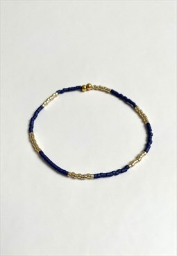Black and gold elastic beaded bracelet. Handmade item.