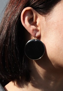 Black enamel round long earrings .