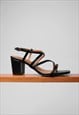 SIDRA MID HIGH BLOCK HEEL SANDALS IN BLACK FAUX LEATHER