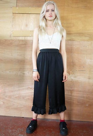 CROP TROUSERS IN BLACK SILKY FABRIC WITH FRILL DETAILS