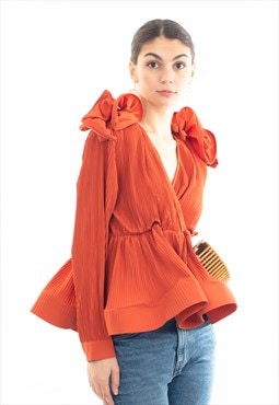 Pleated shirt with ruffle hem and floral design on shoulder 