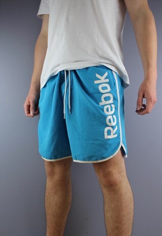 VINTAGE REEBOK SHORTS IN BLUE WITH POCKETS AND PRINTING. HAS