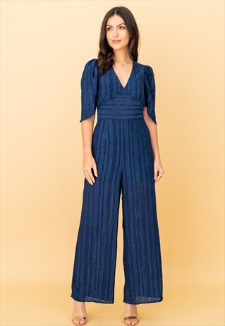V-NECK PLUNGE JUMPSUIT IN NAVY RUFFLE