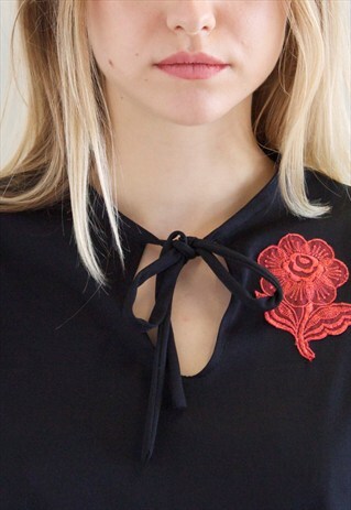 BLACK TIE BOW TOP WITH RED FLOWER DETAIL AND CAPE SLEEVE