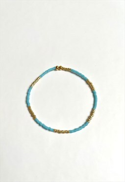 Blue and gold elastic beaded bracelet. Handmade item.