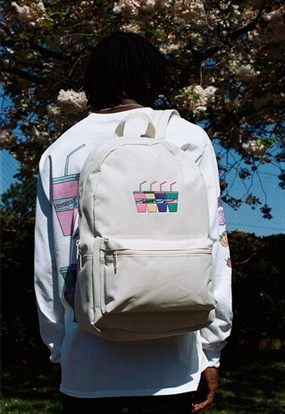BEIGE BACKPACK WITH EMBROIDERED SLUURPEE DESIGN