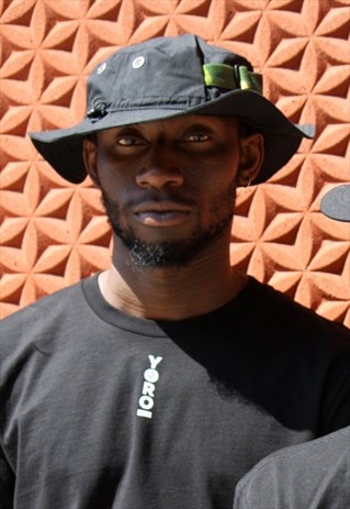 STRAPPED CARGO HAT IN BLACK WITH GREEN CAMOUFLAGE STRAP