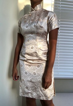 Vintage cheongsam dress in cream and gold.