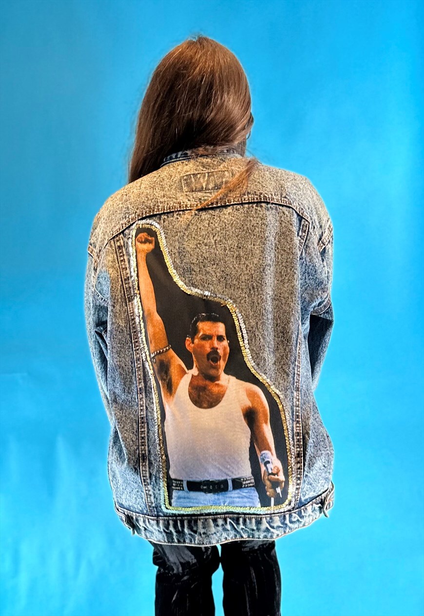 one of the iconic fashion pieces from the 70s. It is completed with  high-heeled boots and crescent-shaped sunglasses. And who could this  mannequin be but Freddie Mercury! Mercury energetically poses on the