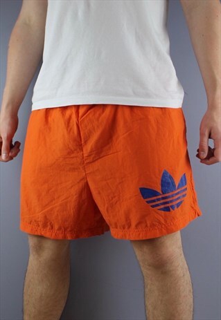 VINTAGE ADIDAS SHORTS IN ORANGE WITH POCKETS AND PRINTED LOG