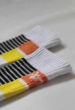 white sports socks with orange, yellow and black stripes
