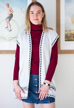 White knitted sleeveless waistcoat