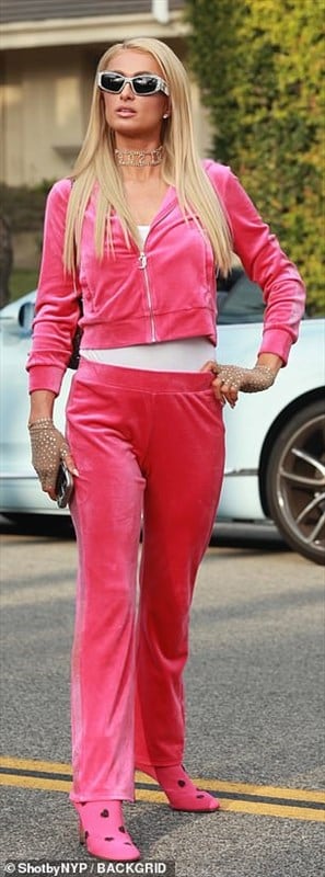 Paris Hilton wearing a bright pink velour tracksuit