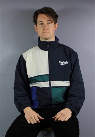 VINTAGE REEBOK WINDBREAKER JACKET IN NAVY BLUE WITH ZIP POCK