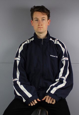 VINTAGE REEBOK ESSENTIALS WINDBREAKER JACKET IN NAVY BLUE WI
