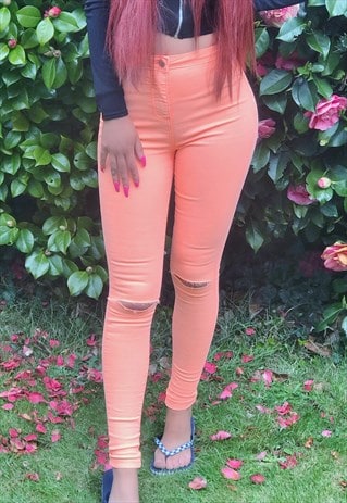 Neon Orange Slashed Knee Skinny Jeans