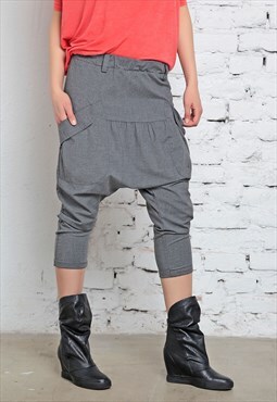 Drop crotch baggy trousers with diagonal side pockets 