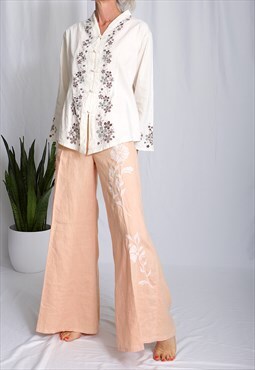 Vintage flared trousers in light orange with embroideries 